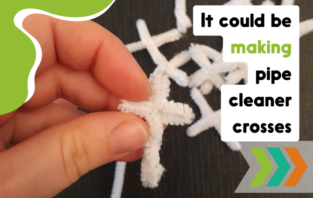 A white cross made out of pipe cleaner. Volunteering could be turning a pipe cleaner into a cross shape